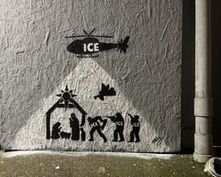 Spray painting an abandoned building for a nativity scene