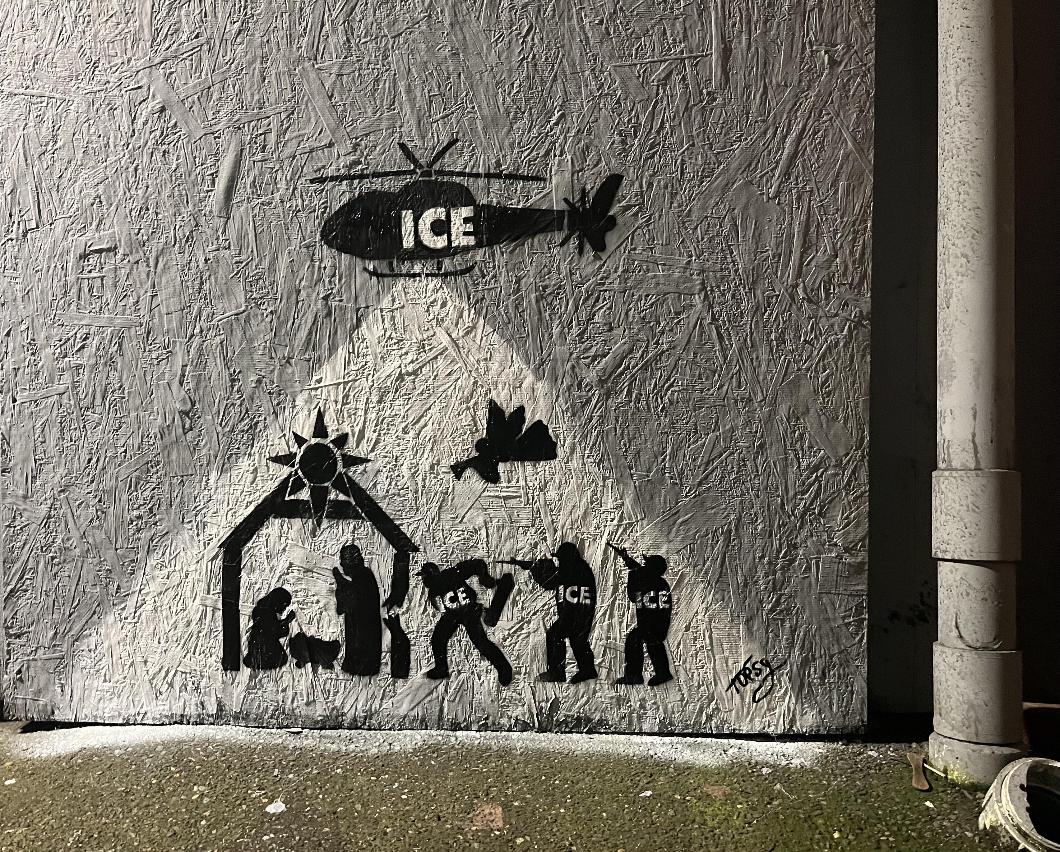 Spray painting an abandoned building for a nativity scene